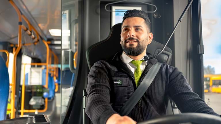 A bus driver steering a bus