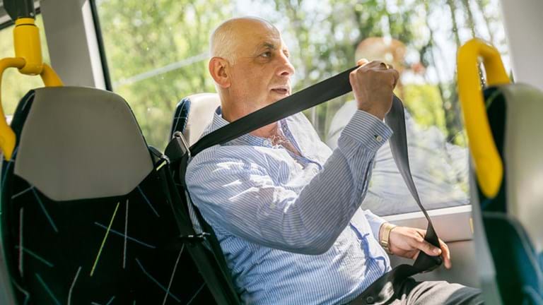 Passenger putting on seat belt